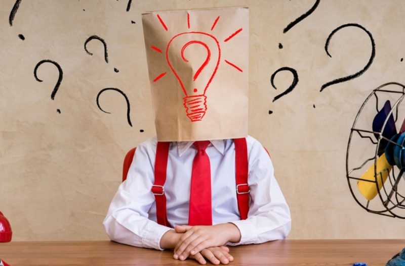 A marketer with a paper bag on his head with a lightbulb drawn on it|A marketing girl throws an agency proposal in the bin||