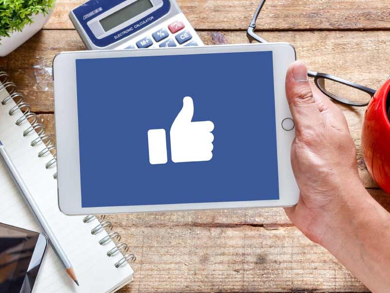 Tablet with Facebook Thumbs up on Screen|how to select See First on a Facebook business page|Teenagers on mobile phones