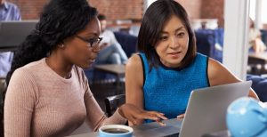 Two women having an informal business consultation