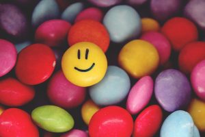 Yellow smartie with a smiley face