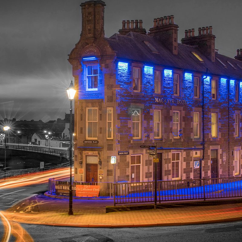 The exterior of Mackays Hotel in Wick lit up at night