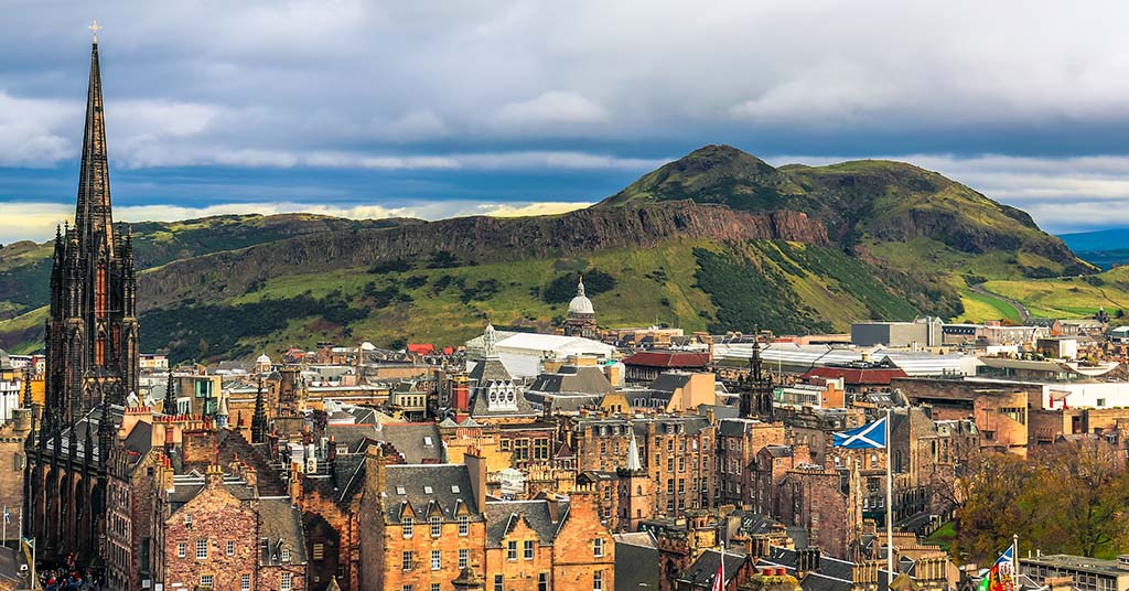 Arthur's Seat towering over Edinburgh on a cloudy day.
