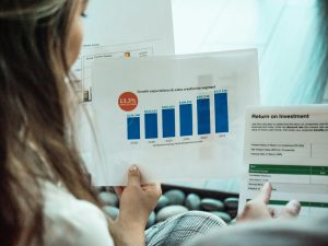 Woman looking at a graph to represent digital marketing ROI